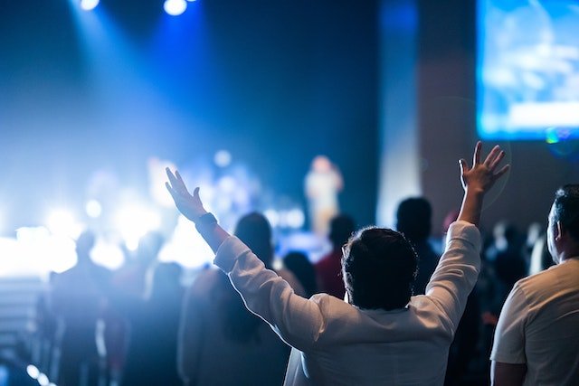 Church Leadership Conferences with hands up